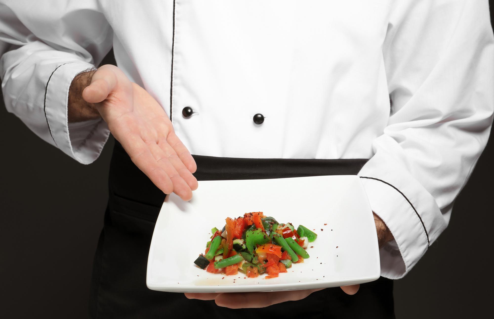 Chef arranging plated tasting menu